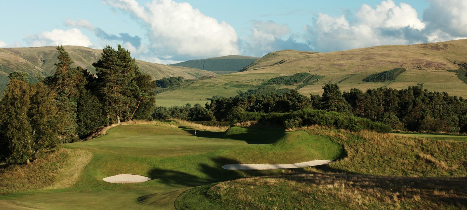 Golfers on a rolling fairway